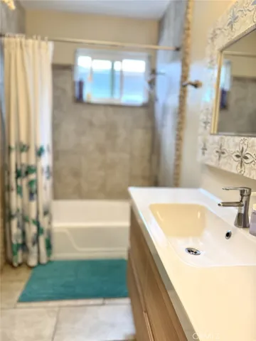 a bathroom with a tub and a sink