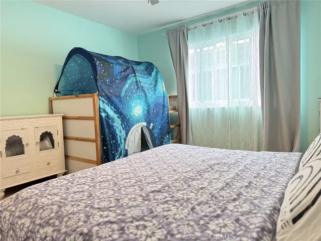 a bedroom with a bed and a dresser