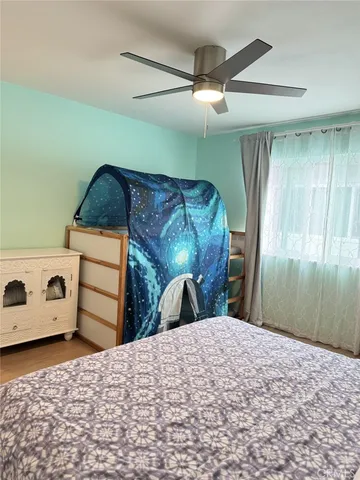a view of bedroom with wooden floor