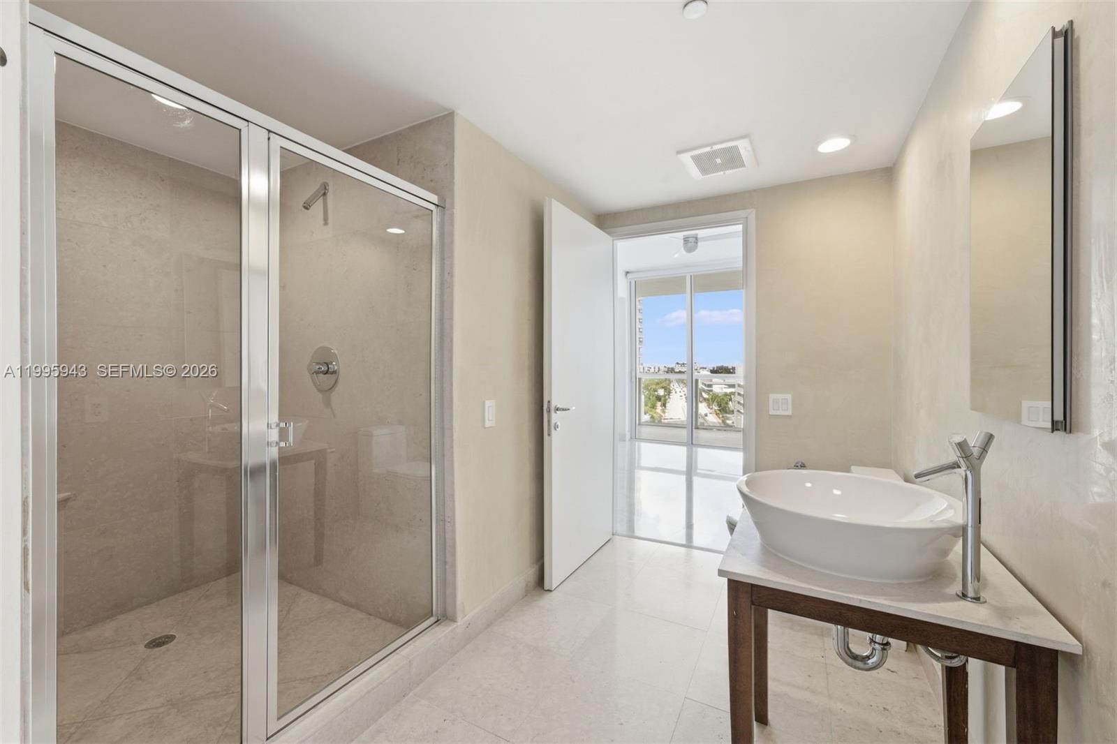450 Alton Road, Unit 910 Miami Beach, FL 33139 - Photo 20 of 59 a bathroom with a sink a mirror and a shower