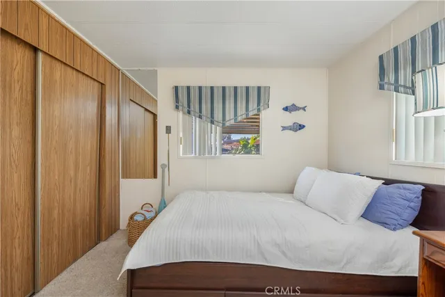 a bedroom with a bed a window and a walk in closet