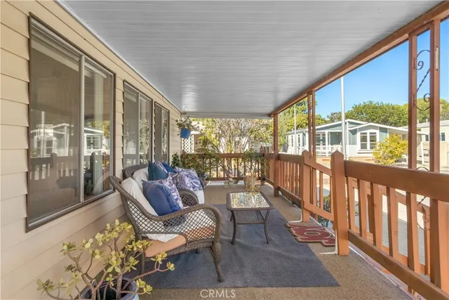 a living room with furniture tv and windows