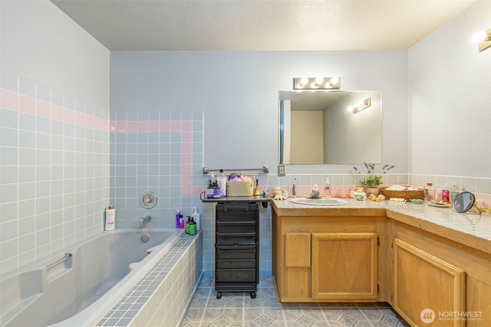 1497 Old Military Road Southeast Tenino, WA 98589 - Photo 17 of 34 a bathroom with a bathtub sink vanity and mirror
