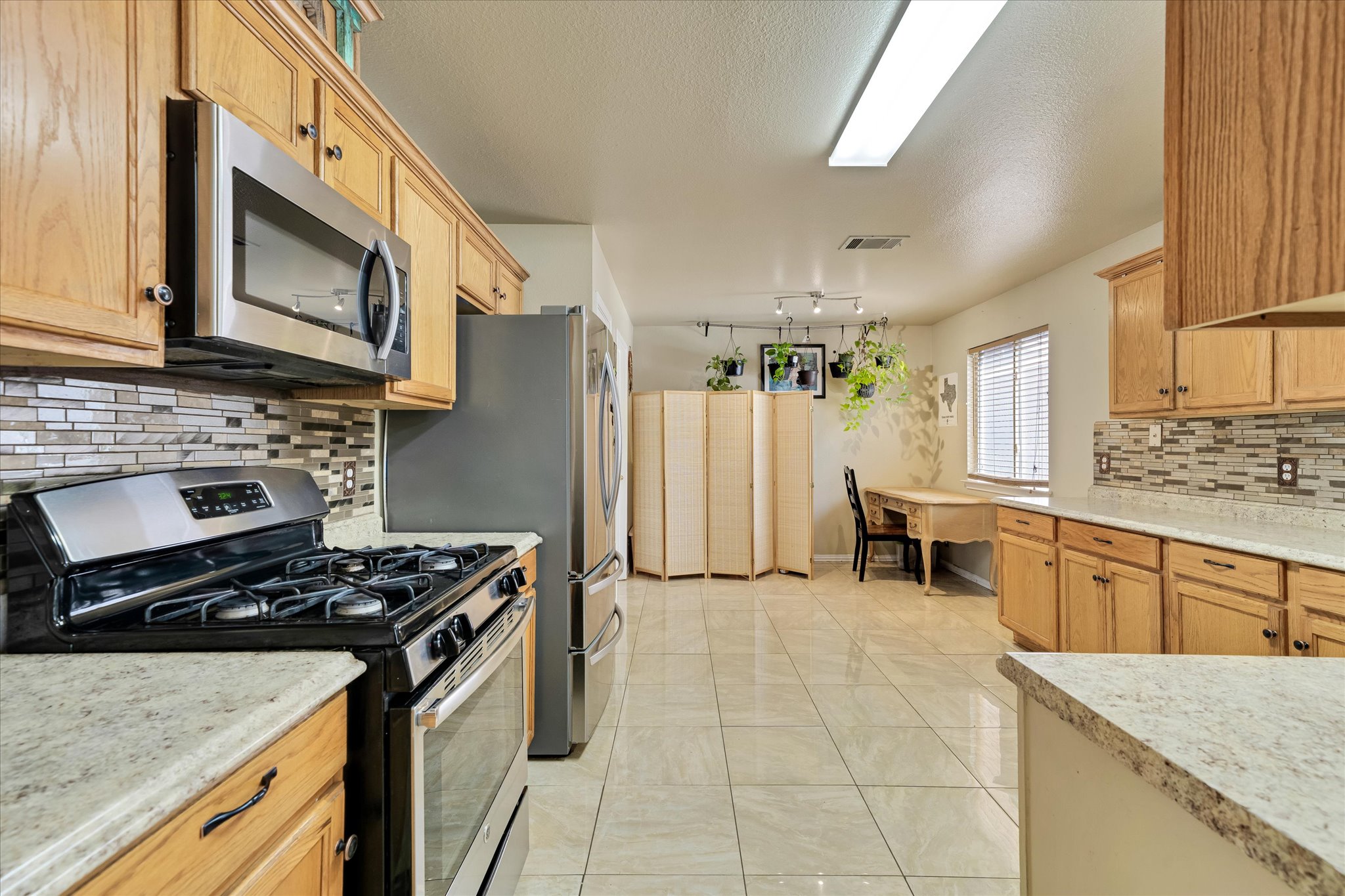 2601 Highcloud Drive Lockhart, TX 78644 - Photo 14 of 30 a kitchen with a stove a sink and a microwave