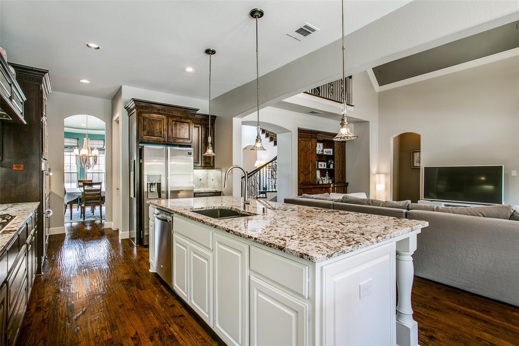 1518 Saddle Tree Road Frisco, TX 75036 - Photo 14 of 40 a kitchen with stainless steel appliances granite countertop a sink and a refrigerator