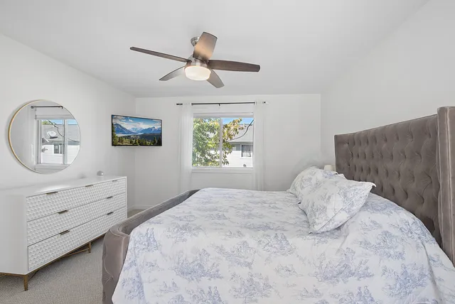 a bedroom with a large bed and a window