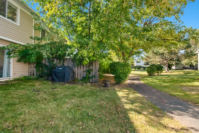 a backyard of a house with table and chairs