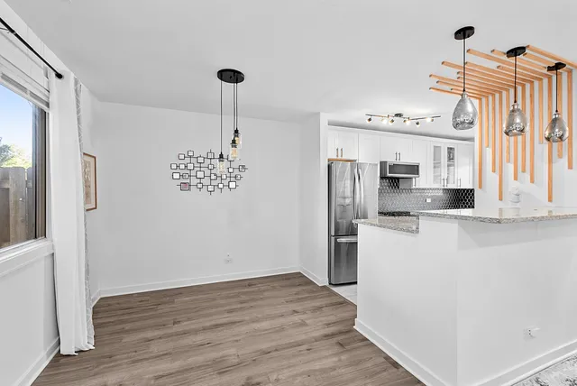 a kitchen with stainless steel appliances a refrigerator sink and cabinets