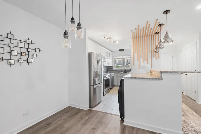 a view of a kitchen with wooden floor