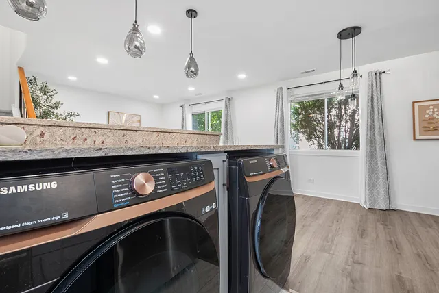 a view of a kitchen with a stove fridge and wooden floor