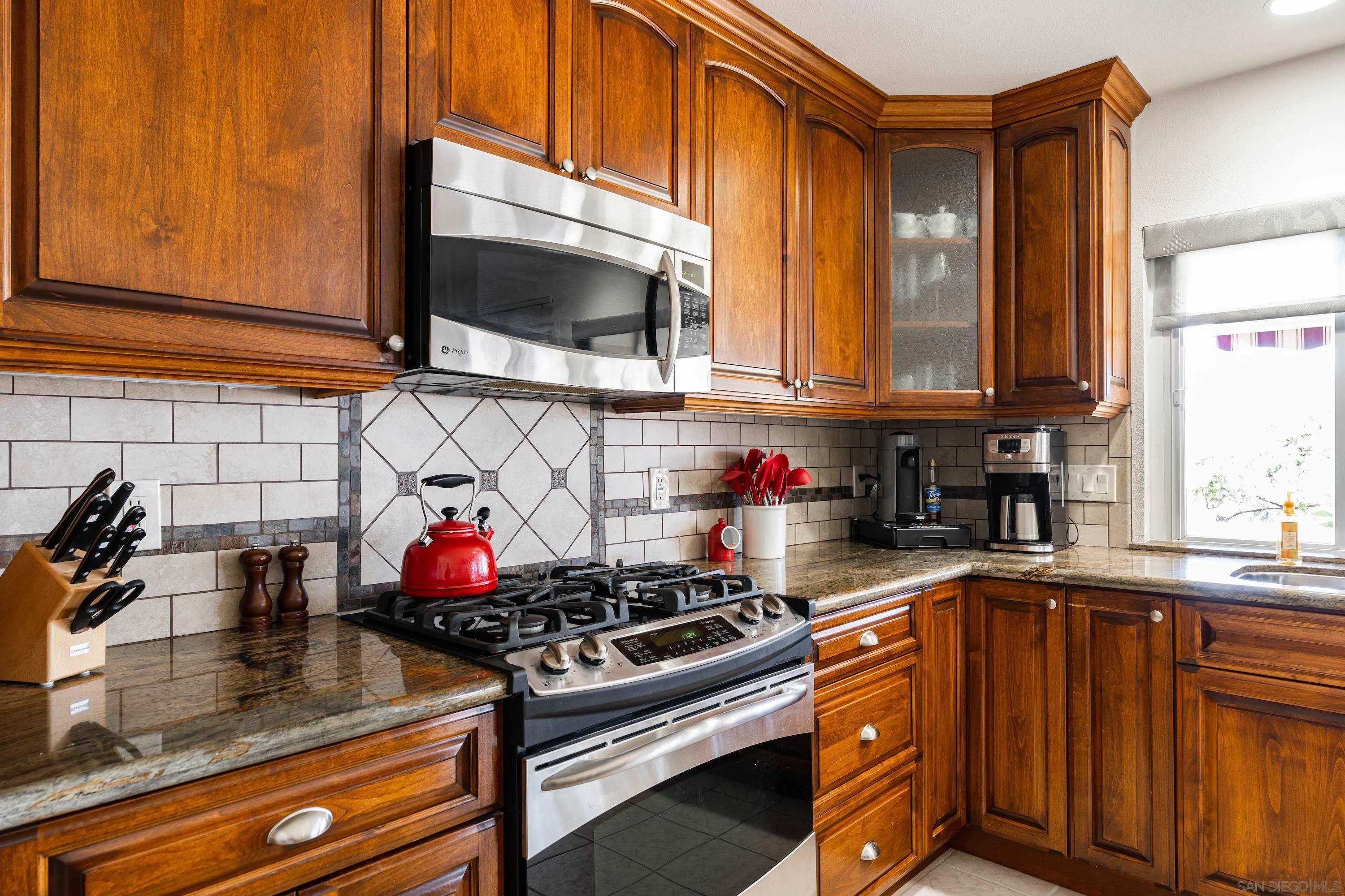 4166 Kimberly Lane Oceanside, CA 92056 - Photo 11 of 25 a kitchen with stainless steel appliances granite countertop a sink stove and microwave