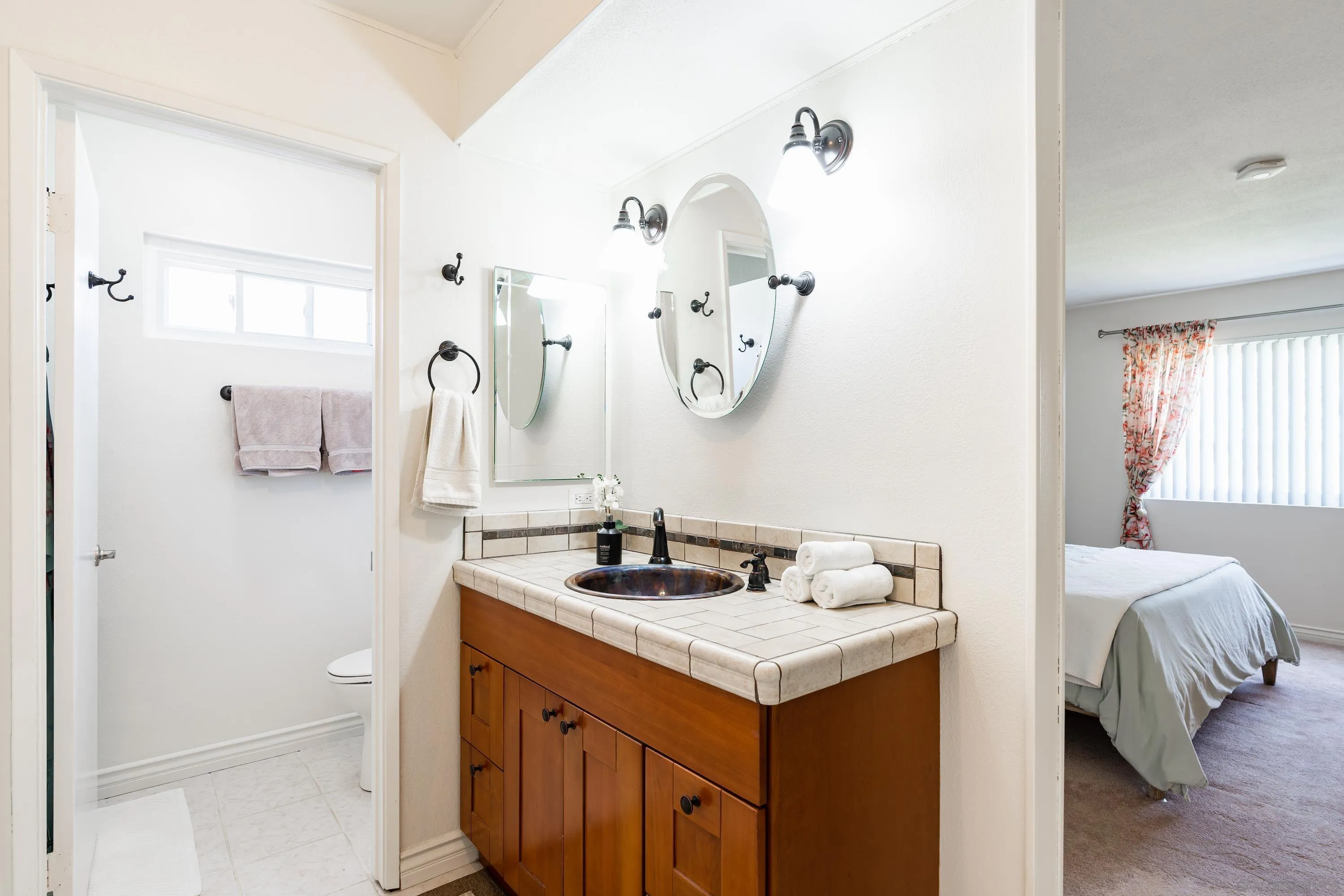 4166 Kimberly Lane Oceanside, CA 92056 - Photo 13 of 25 a bathroom with a sink and a mirror