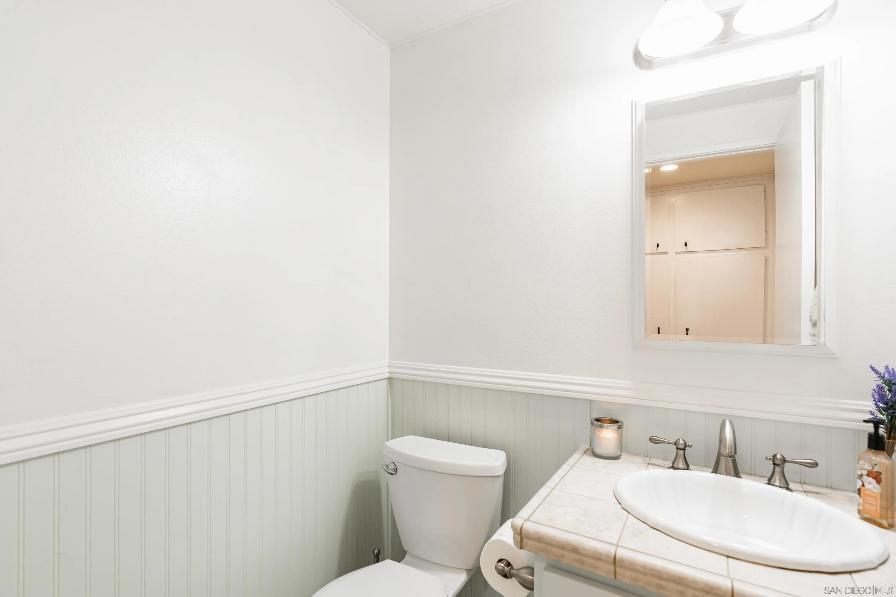 4166 Kimberly Lane Oceanside, CA 92056 - Photo 15 of 25 a bathroom with a toilet sink and mirror