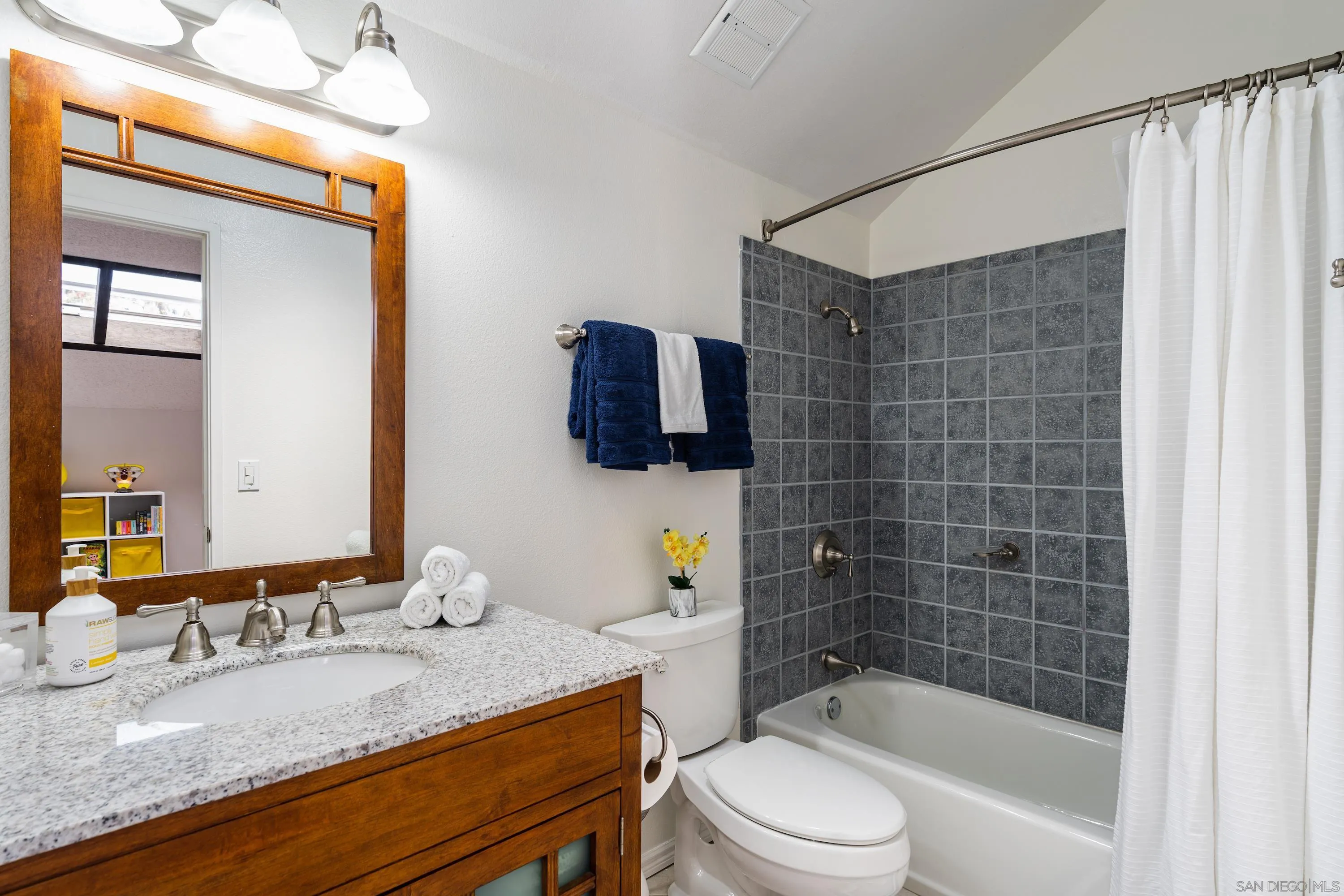 4166 Kimberly Lane Oceanside, CA 92056 - Photo 18 of 25 a bathroom with a granite countertop sink toilet and shower