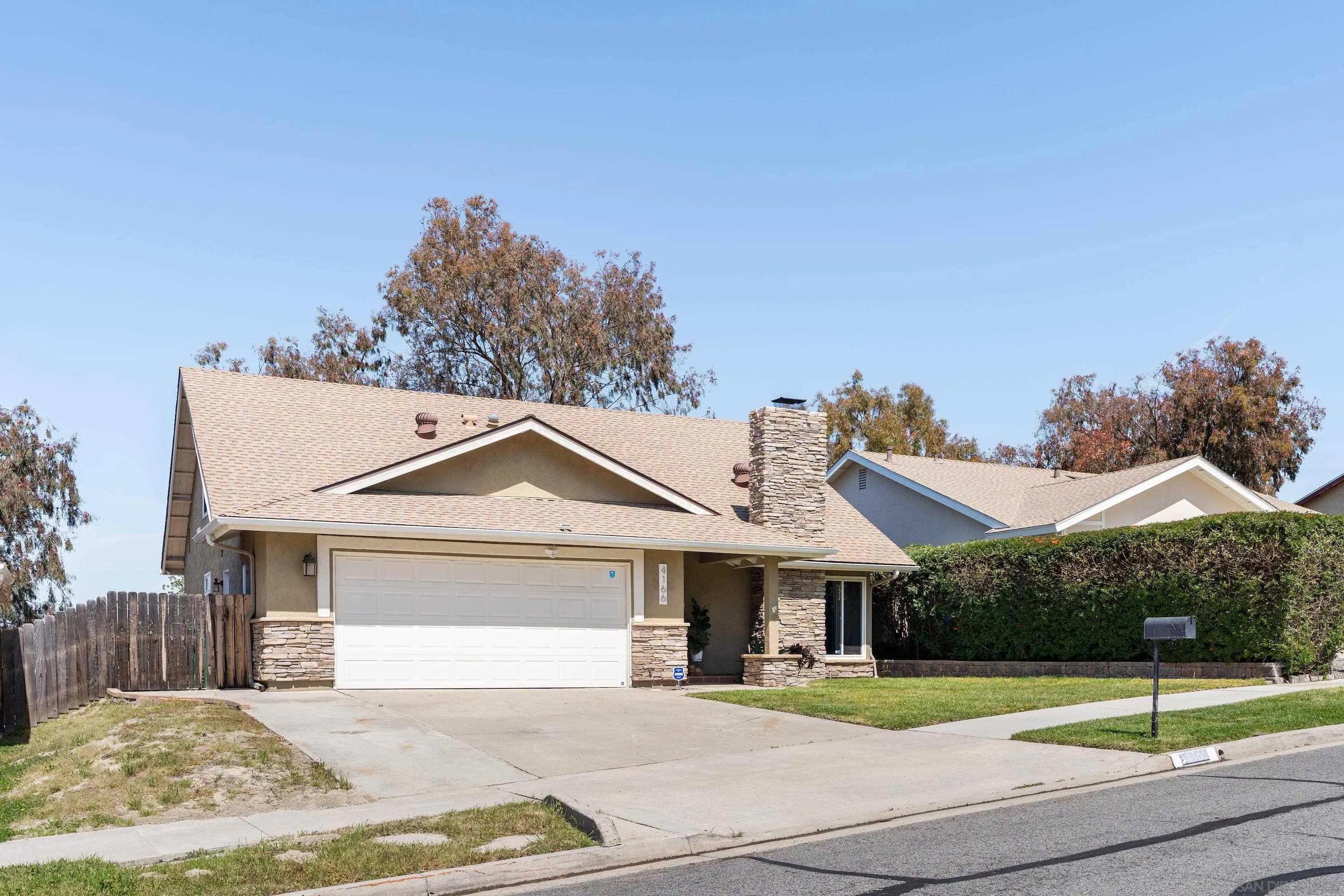 4166 Kimberly Lane Oceanside, CA 92056 - Photo 2 of 25 a view of a big house with a big yard and large trees