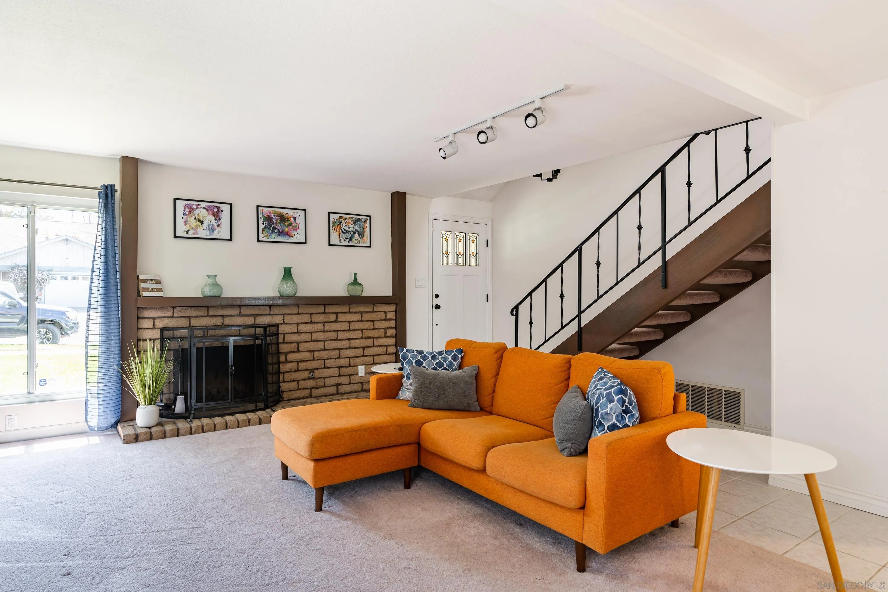 4166 Kimberly Lane Oceanside, CA 92056 - Photo 6 of 25 a living room with furniture a flat screen tv and a fireplace