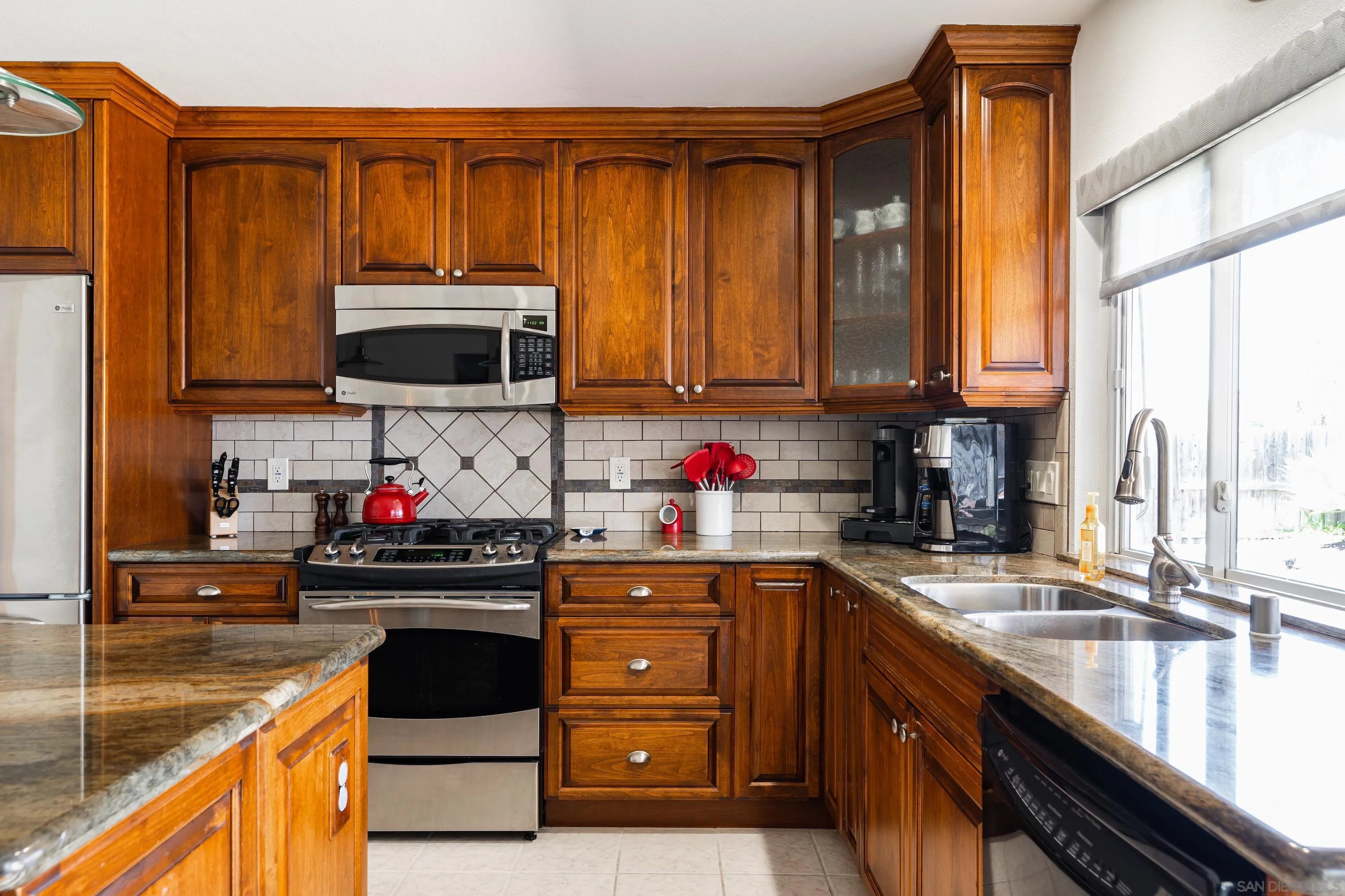 4166 Kimberly Lane Oceanside, CA 92056 - Photo 10 of 25 a kitchen with granite countertop a sink stove and cabinets