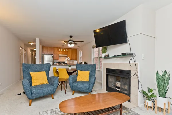 a living room with furniture a flat screen tv and a fireplace