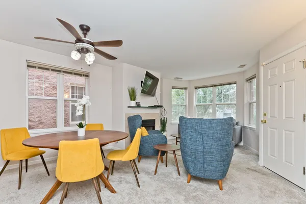 a dining room with furniture and a window