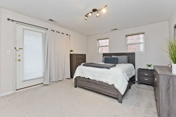 a bedroom with a bed dresser and a window