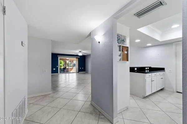 a kitchen with granite countertop white cabinets sink and window