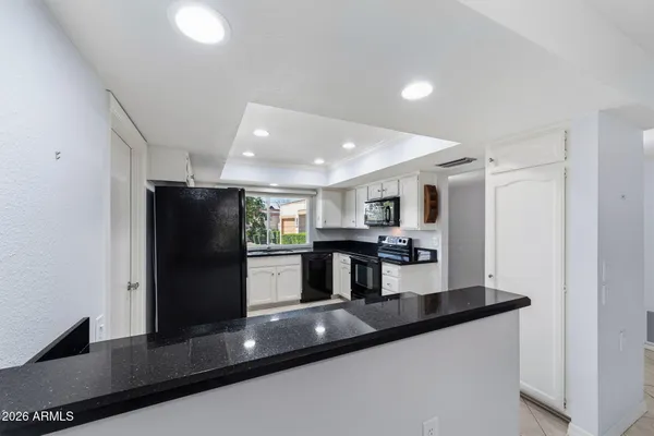 a front view of a house with a garden and yard