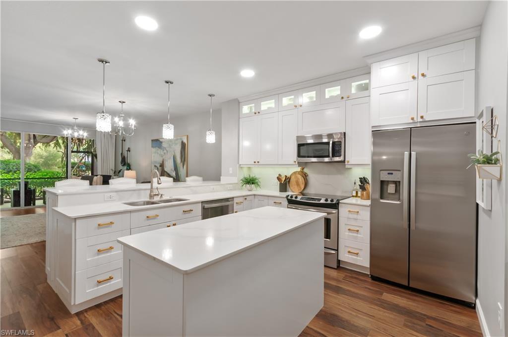 a kitchen with a sink stainless steel appliances and cabinets