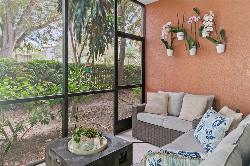 10020 Heather Lane, Unit 901 Naples, FL 34119 - Photo 14 of 34 a living room with furniture and a floor to ceiling window