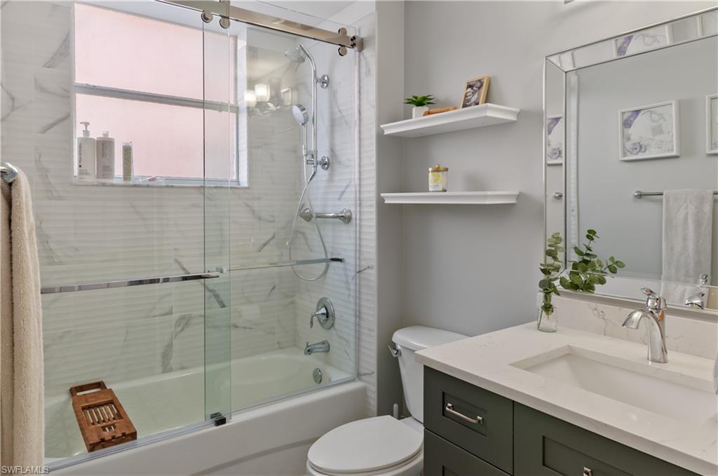 10020 Heather Lane, Unit 901 Naples, FL 34119 - Photo 17 of 34 a bathroom with a sink toilet and shower