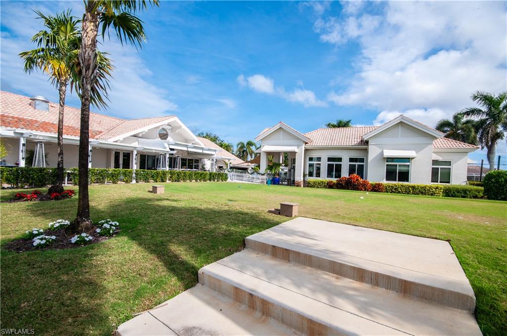 10020 Heather Lane, Unit 901 Naples, FL 34119 - Photo 28 of 34 a front view of house with yard and green space