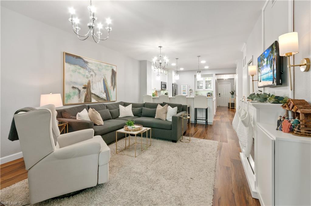 10020 Heather Lane, Unit 901 Naples, FL 34119 - Photo 10 of 34 a living room with furniture and a chandelier