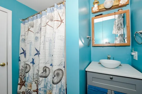 a bathroom with a sink mirror and vanity