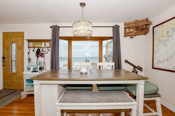 a living room with furniture a rug and a chandelier