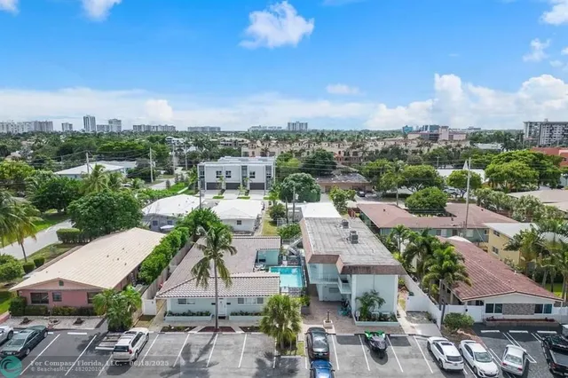 a view of a balcony with chairs potted plants
