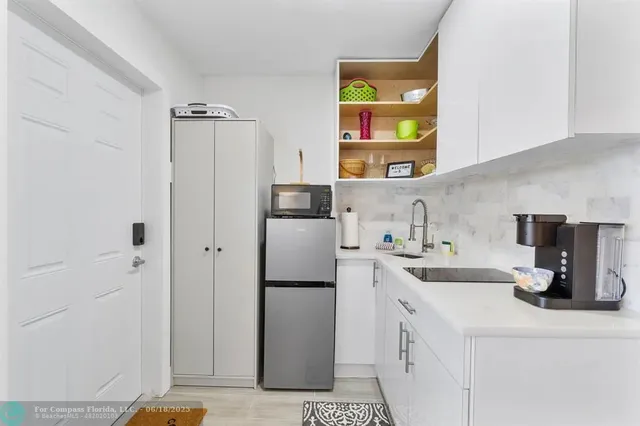 a kitchen with a refrigerator and a sink