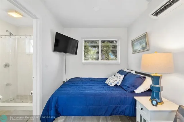 a bedroom with a bed and a flat screen tv