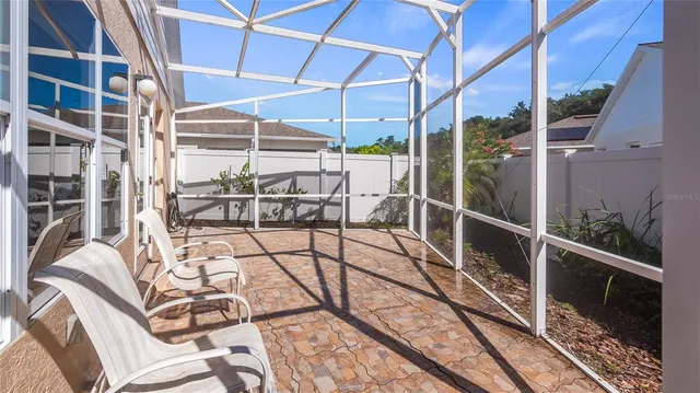 a view of a patio with table and chairs with wooden fence and plants
