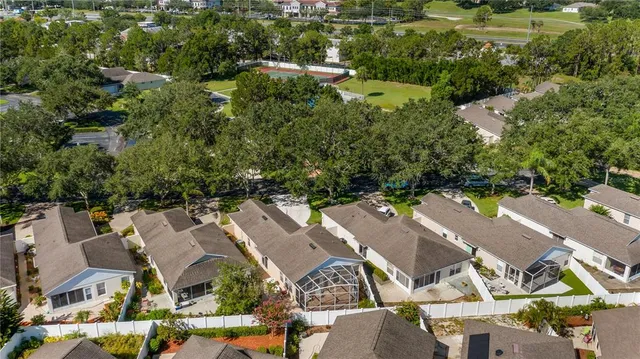 an aerial view of residential houses with outdoor space and river