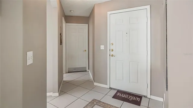 a living room with furniture a chandelier and a flat screen tv