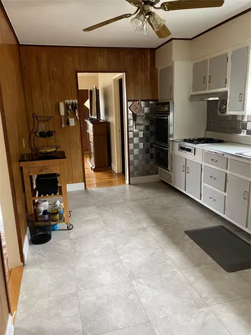 a kitchen with refrigerator and cabinets