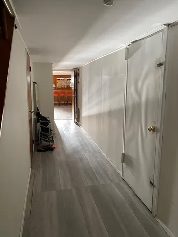 a view of a hallway to a livingroom with a staircase