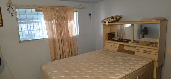 a bedroom with two beds and a lamp