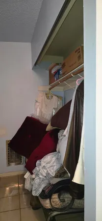 a bedroom with furniture and a mirror