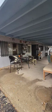 a view of a patio with couches table and chairs and potted plants