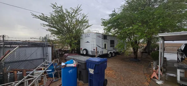 a living room with a large window and furniture