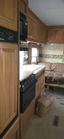 a view of a patio with table and chairs and wooden fence
