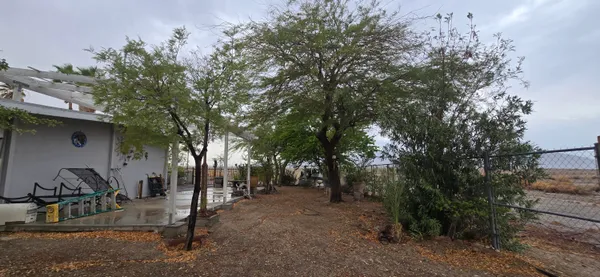 an aerial view of house with yard and swimming pool