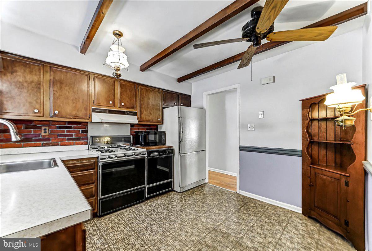 123 Reybold Drive Delaware City, DE 19706 - Photo 12 of 30 a kitchen with stainless steel appliances granite countertop a refrigerator a stove and a sink with wooden floor