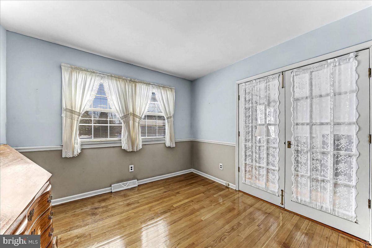 123 Reybold Drive Delaware City, DE 19706 - Photo 16 of 30 a view of an empty room with wooden floor and a window