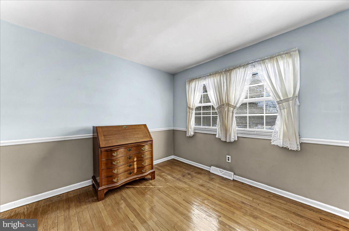 123 Reybold Drive Delaware City, DE 19706 - Photo 17 of 30 an empty room with wooden floor and windows